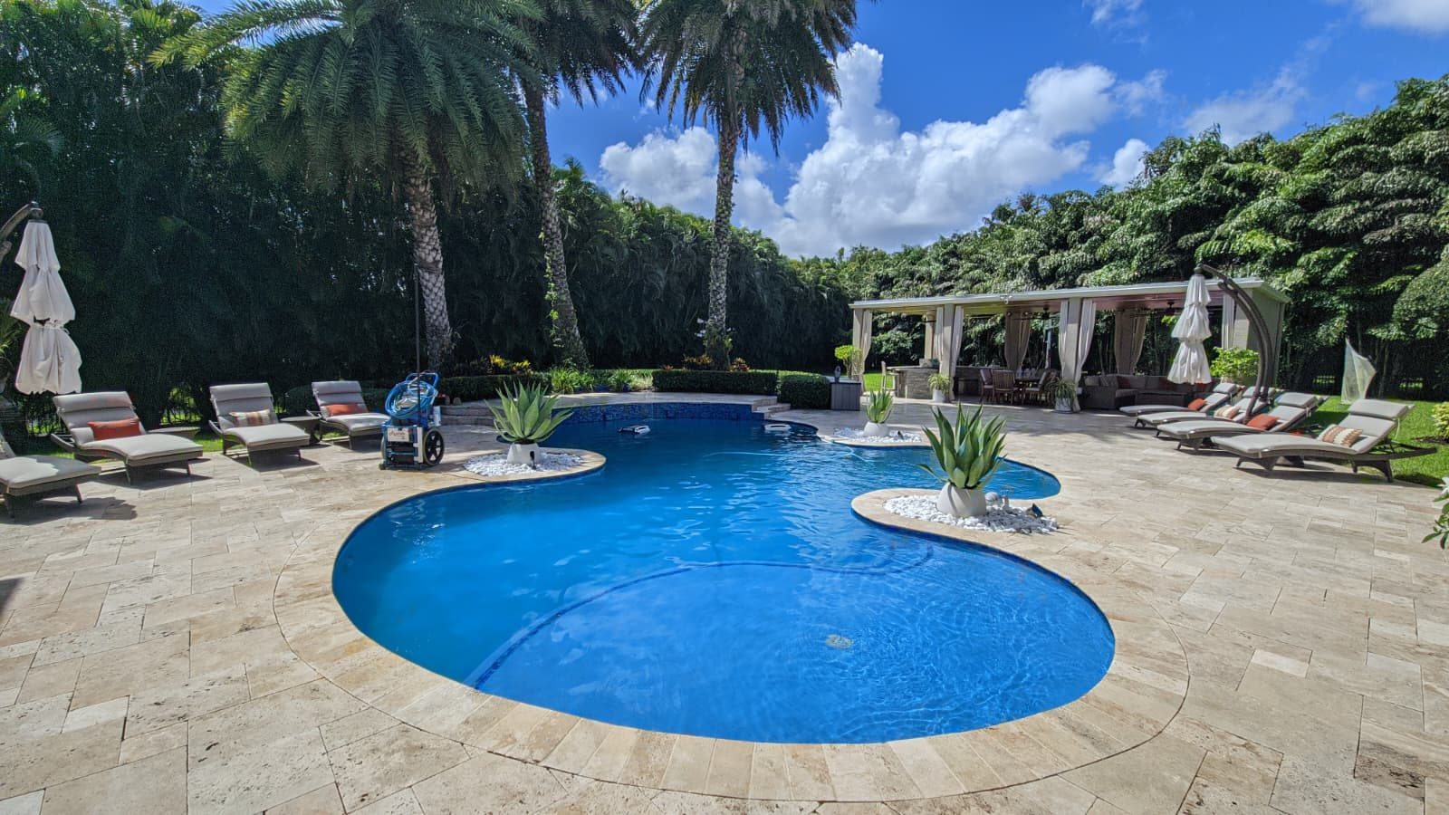 Clean tropical pool serviced by Emanuel Pools in Boca Raton